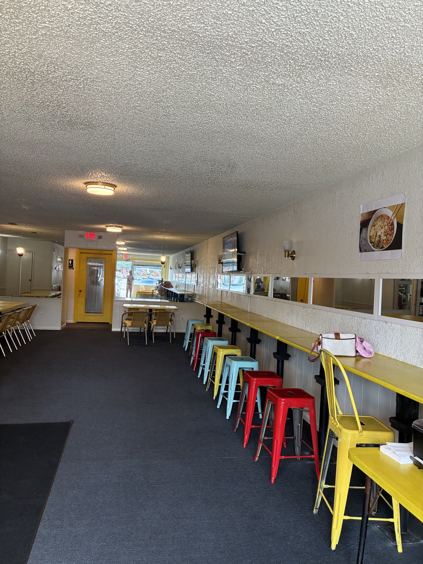 The welcoming counter and colorful stools inside K Bunsik